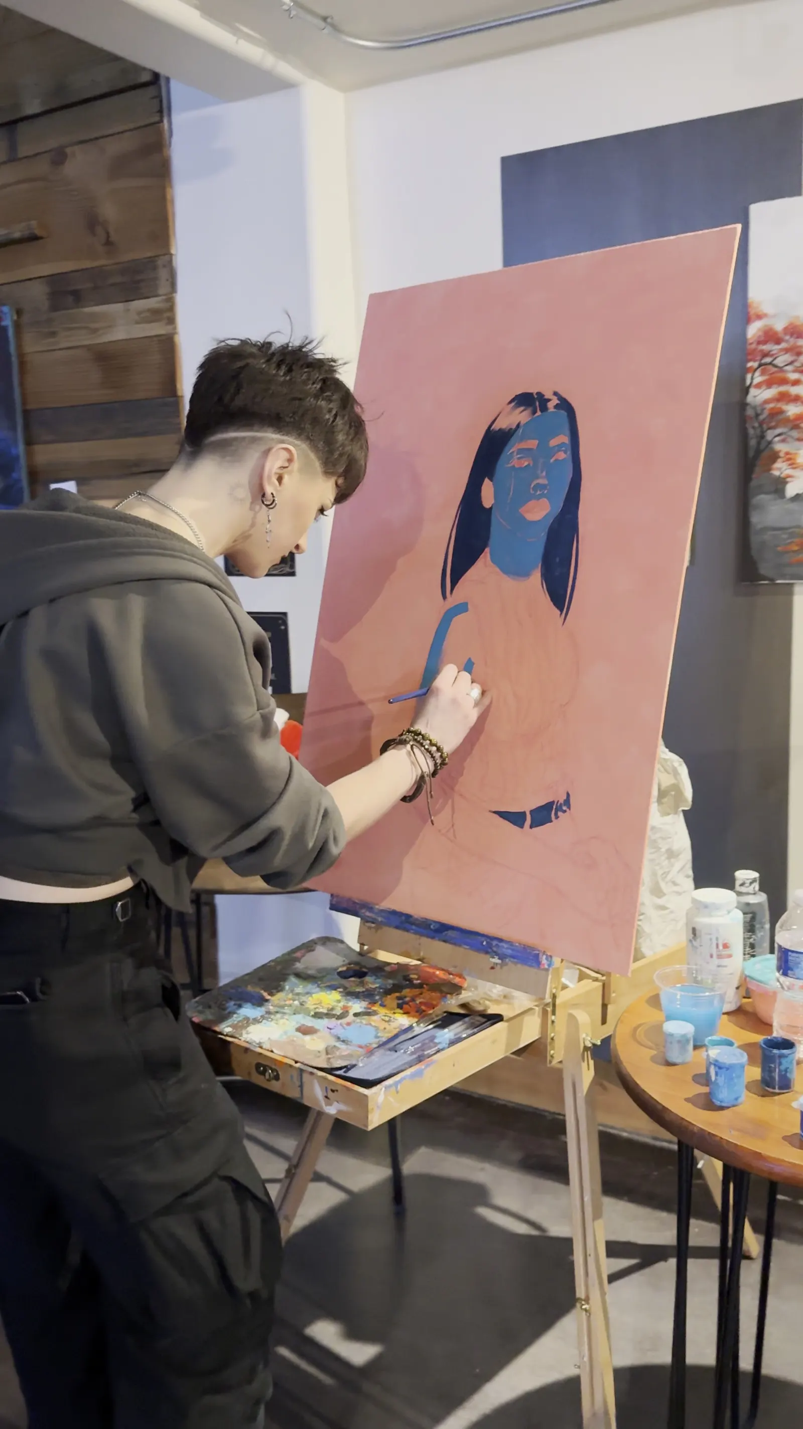 An artist painting a canvas live during a party in the Back Venue at 1712 Studios