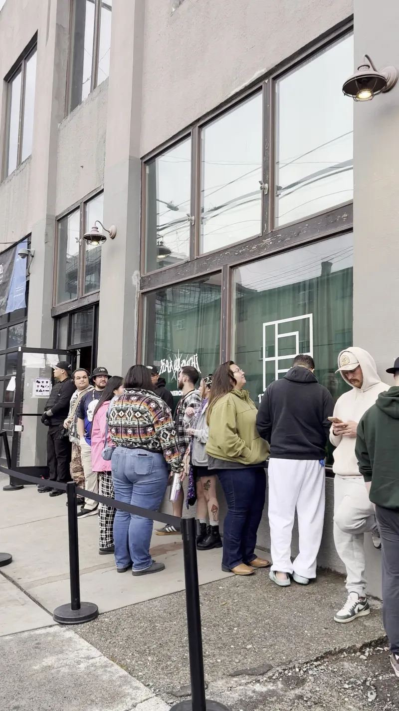A line of shoppers waiting outside the front windows of 1712 Studios on 1st Ave S for a pop up