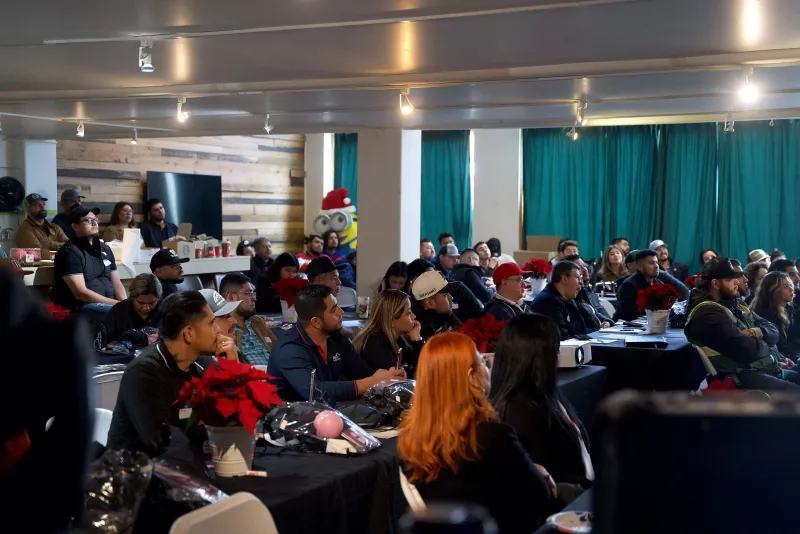 A full room of attendees at round tables for a corporate training in the Main Hall at 1712 Studios