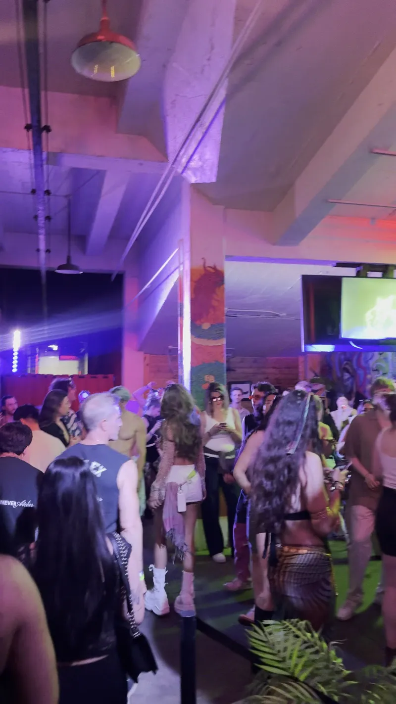A full dance floor under purple light in the Back Venue at 1712 Studios