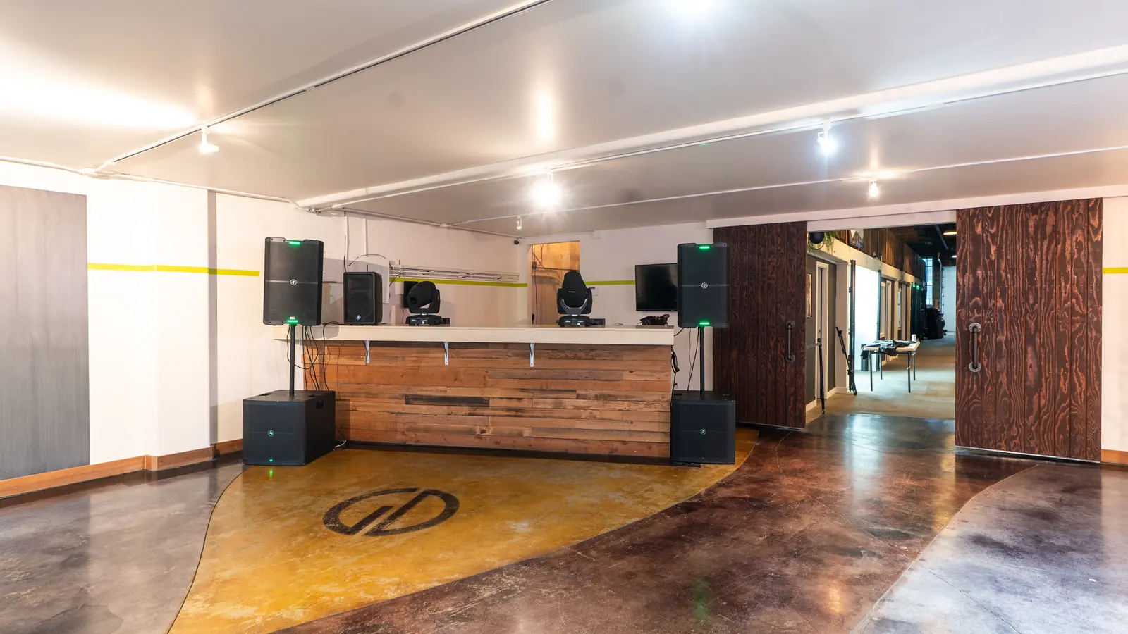 The DJ booth with Mackie speakers and subwoofers in the Main Hall at 1712 Studios