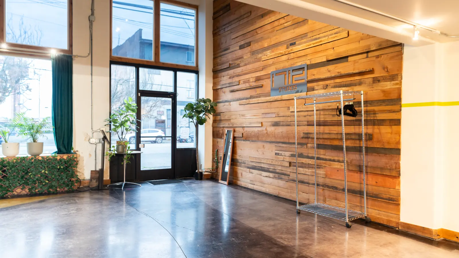The glass entrance and the 1712 sign on the reclaimed wood wall inside the Main Hall