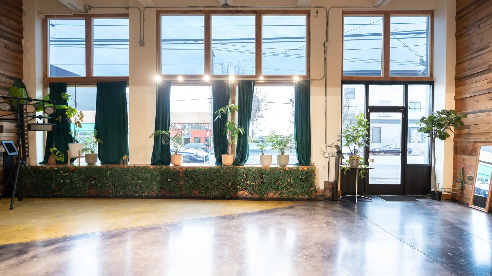 Floor to ceiling front windows and the glass entry door of the Main Hall at 1712 Studios on 1st Avenue South