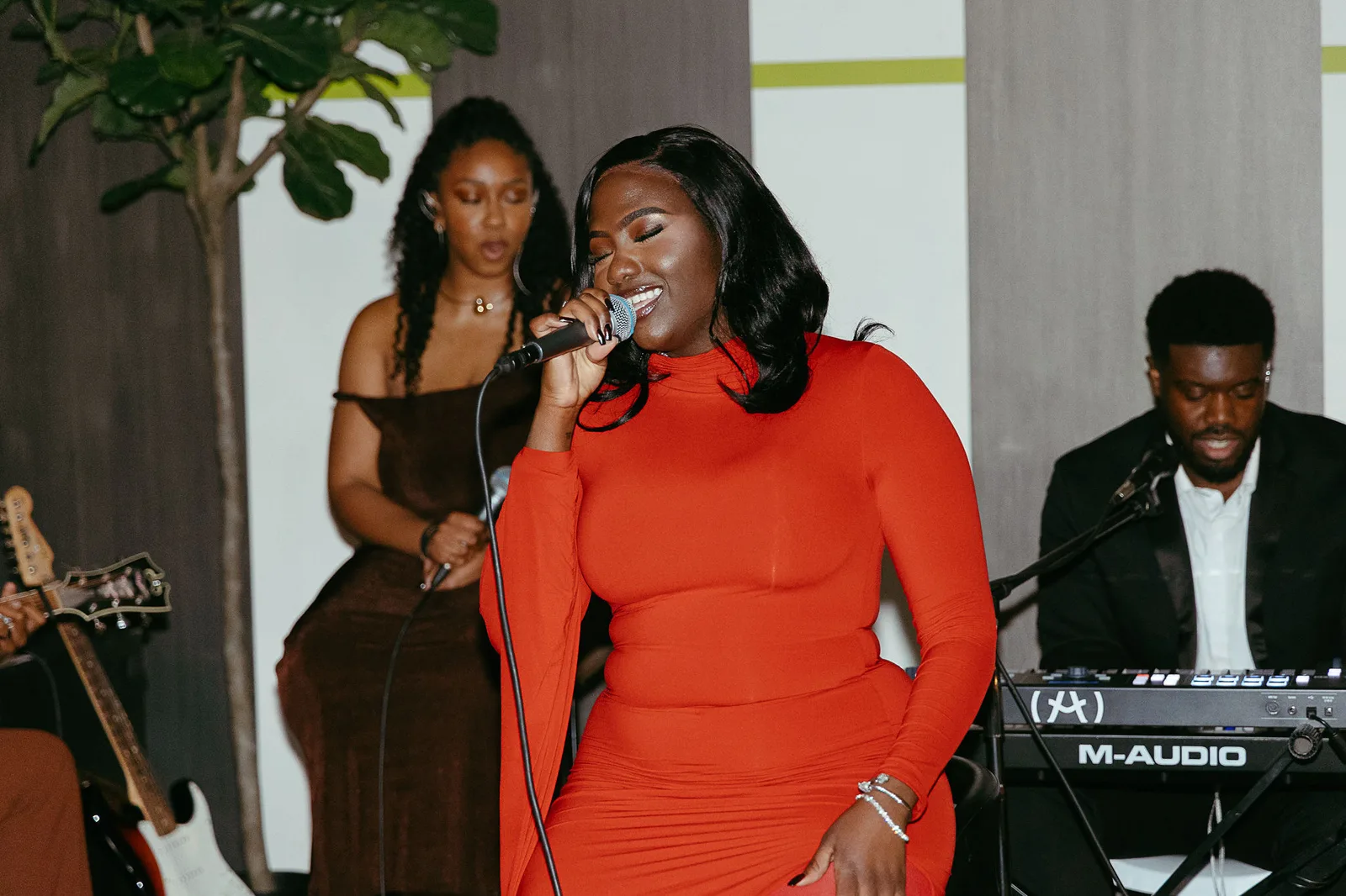 A singer at the mic with a keys player at a live show in the Main Hall at 1712 Studios