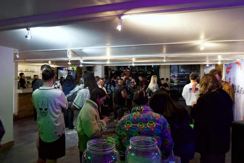 A crowd filling the Main Hall at 1712 Studios on a pop up night, seen from the bar