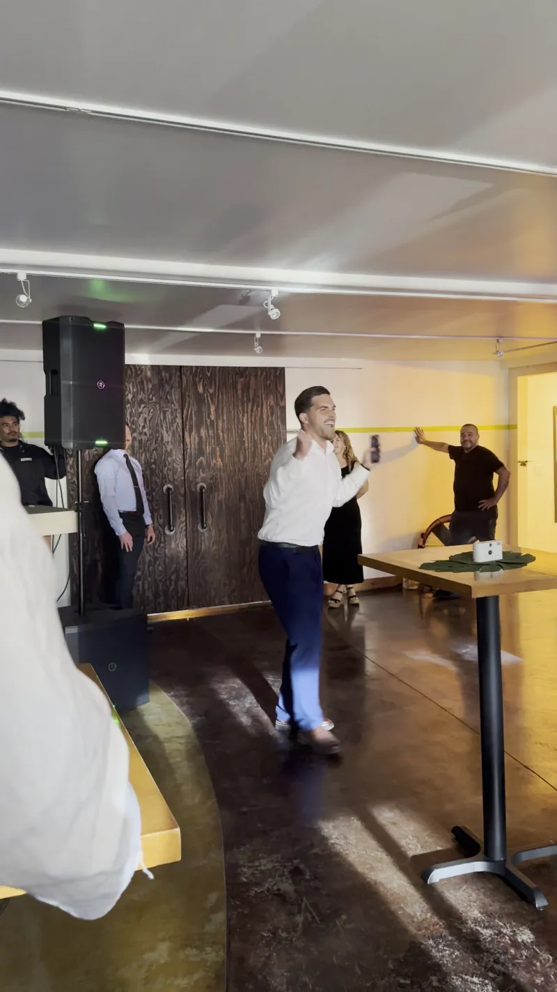 A groomsman giving a toast with a microphone at a wedding in the Main Hall at 1712 Studios