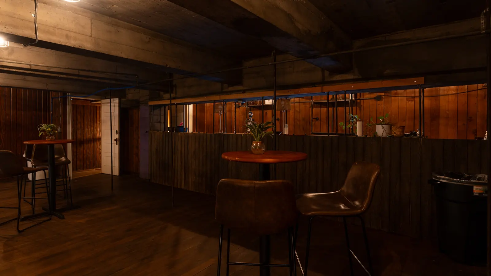 Cocktail tables and leather stools in the Speakeasy at 1712 Studios