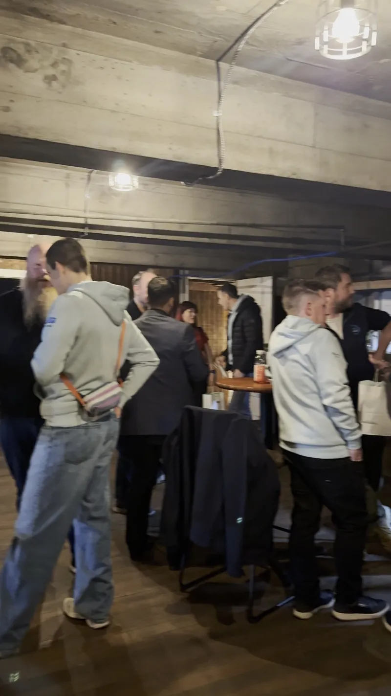 A company group standing at the Speakeasy bar upstairs at 1712 Studios with drinks